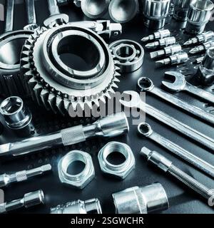 Collection of various metallic tools arranged neatly on a dark surface showing different sizes and types Stock Photo