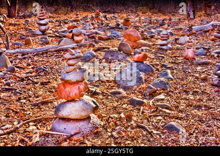 Pile of rocks with a few stacked on top of each other. The rocks are brown and gray Stock Photo