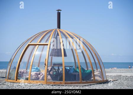 Transparent bubble dome on the seashore on fine sand. The perfect place to relax. With space to copy. High quality photo Stock Photo
