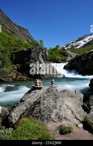 Rock sculptures beside a fast flowing river alongside the Gamle Strynefjellsvegen national tourist route at Hotel Videseter, Norway, on midsummers day. Stock Photo