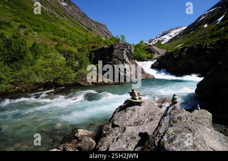 Rock sculptures beside a fast flowing river alongside the Gamle Strynefjellsvegen national tourist route at Hotel Videseter, Norway, on midsummers day. Stock Photo