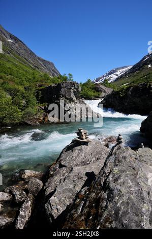 Rock sculptures beside a fast flowing river alongside the Gamle Strynefjellsvegen national tourist route at Hotel Videseter, Norway, on midsummers day. Stock Photo