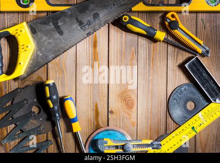 Useful tools laid out on a wooden surface for various home improvement projects and repairs Stock Photo