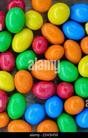 A variety of dragee candies in multi-colored glaze, close up shot, abstract confectionery food background Stock Photo