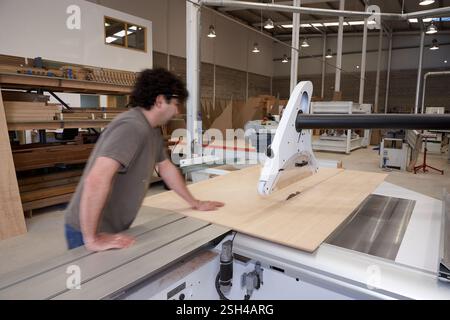 Man Operating a Table Saw for Woodwork in Carpentry Workshop Stock Photo