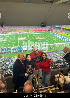 U.S. President Donald Trump, left, poses for selfies with Patrick Mahomes family while in the stands at the Super Bowl, February 9, 2025 in New Orleans, Louisiana. Stock Photo