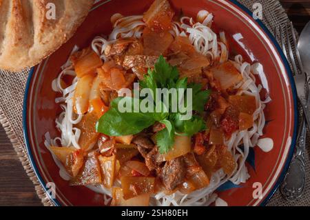 Hot Uighur dish served with herbs and flatbread Stock Photo
