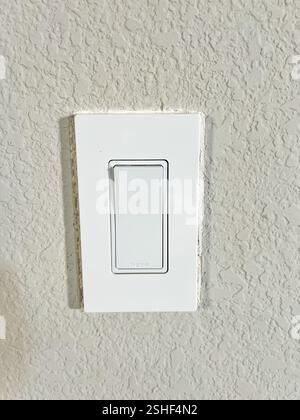 White modern light switch on textured wall Stock Photo