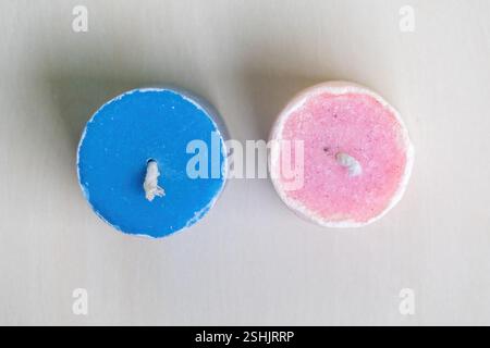 Two beautiful new pink and blue fireless candles displayed on a white background. Top view. Stock Photo