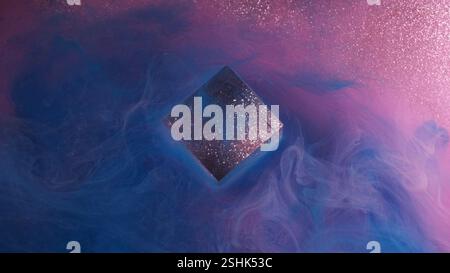 Splash glitter ink. Smoke texture, Bright blue pink purple colorful flow cube cloud paint vapor on abstract shimmering background. Stock Photo