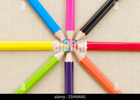 Colorful sharpened pencils are lined up on the table. Flat lay Stock Photo