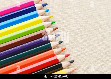 Colorful sharpened pencils are lined up on the table. Flat lay Stock Photo