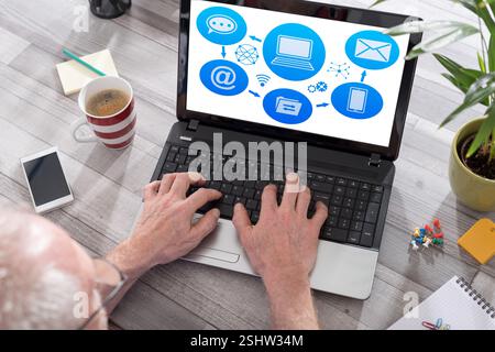 Email sending concept shown on a laptop used by a man Stock Photo
