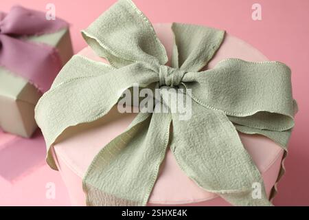 Different gift boxes with bows on pink background, closeup Stock Photo
