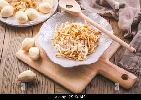 Semolina dumplings and pancake noodles for soup, preparing broth with noodles Stock Photo