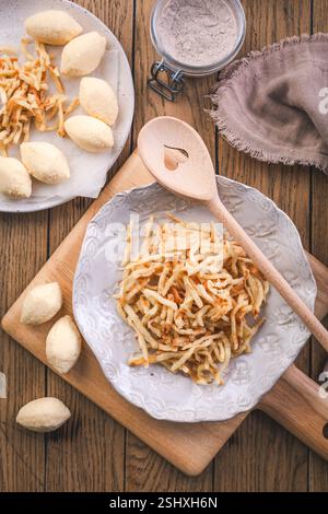 Semolina dumplings and pancake noodles for soup, preparing broth with noodles Stock Photo