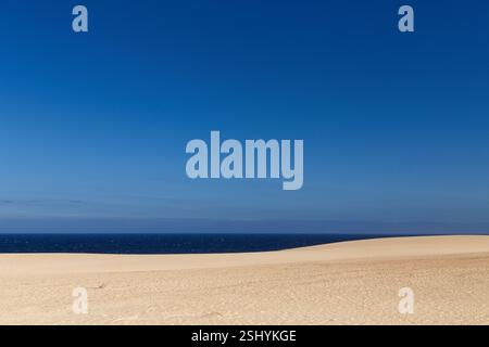 Endless Dunes and Deep Blue Sea Stock Photo