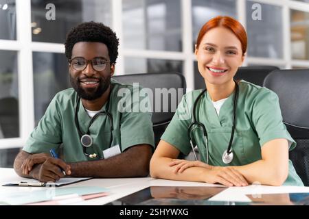 Professionals surgeon and colleague collaborating on treatment plans in hospital office Stock Photo