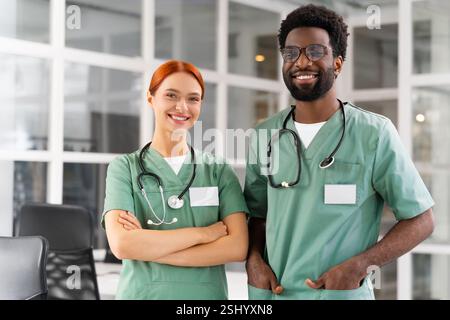 Diverse team of doctors and healthcare professionals posing together in clinic Stock Photo