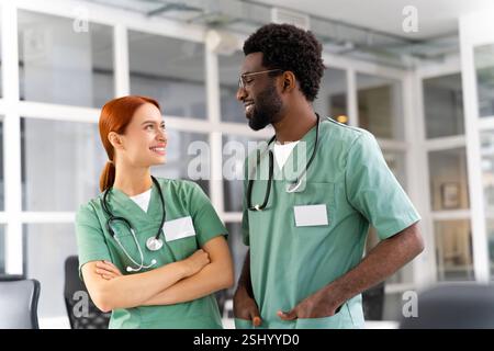 Diverse team of doctors and healthcare professionals posing together in clinic Stock Photo