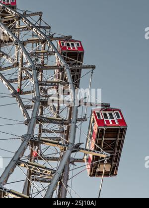 Wiener Riesenrad in Vienna, Austria. Historic tall Ferris wheel with red gondolas at the entrance of the Prater amusement park. Stock Photo
