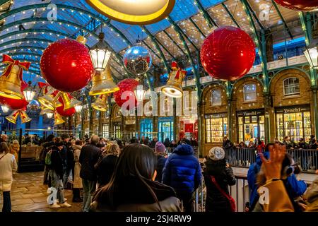 Christmas lights and decorations hanging from the roof of The South Hall in Covent Garden,a shopping and entertainment hub in London,WC1 ,UK Stock Photo