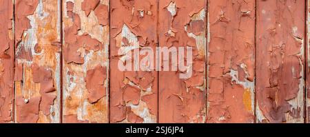 Panorama peeling paint on a weathered red wooden wall texture background Stock Photo