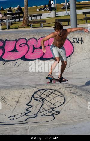 Urban extreme sport park. Young skateboarder performs stunts with a skateboard Stock Photo