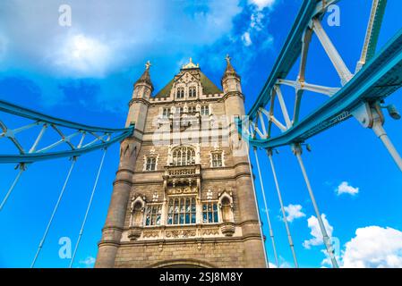 Great close-up view of one of the twin towers of London's iconic Tower Bridge with the suspension cables on each side. The combined bascule and... Stock Photo