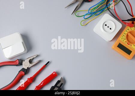 Different electrical tools on grey background, flat lay. Space for text Stock Photo