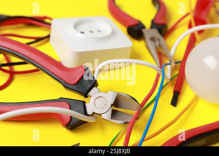 Different electrical tools on yellow background, closeup Stock Photo