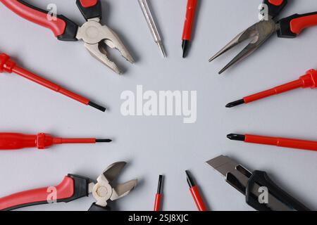 Frame of different electrical tools on grey background, flat lay. Space for text Stock Photo