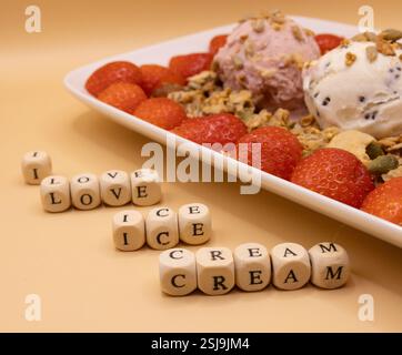 A plate of ice cream scoops with strawberries and granola for ice cream for breakfast day Stock Photo