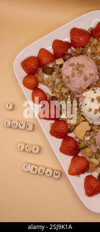A plate of ice cream scoops with strawberries and granola for ice cream for breakfast day Stock Photo