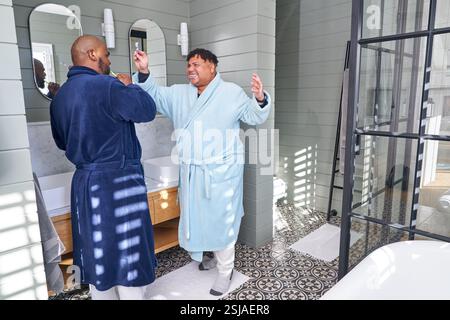 Gay couple brushing teeth Stock Photo