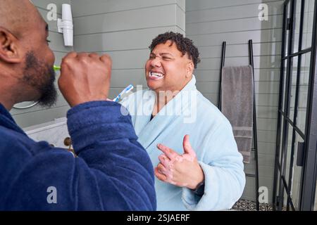 Gay couple brushing teeth Stock Photo