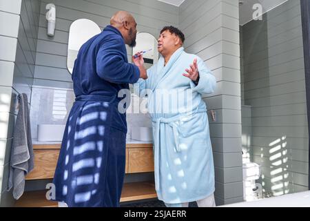 Gay couple brushing teeth Stock Photo