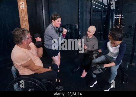 Friends exercising in gym Stock Photo