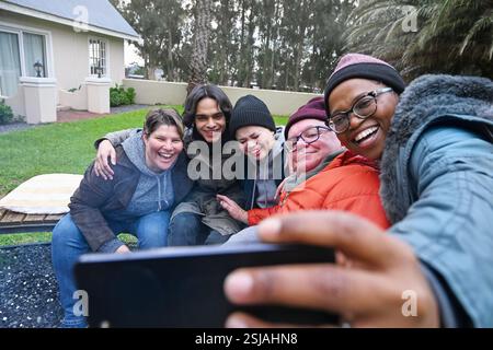 Friends by fire pit in garden Stock Photo