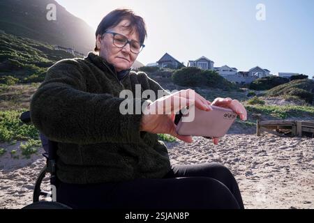 Woman in a wheelchair taking a selfie with her family Stock Photo - Alamy