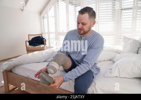 Man attaching leg prosthesis Stock Photo