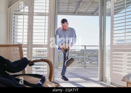 Man attaching leg prosthesis Stock Photo
