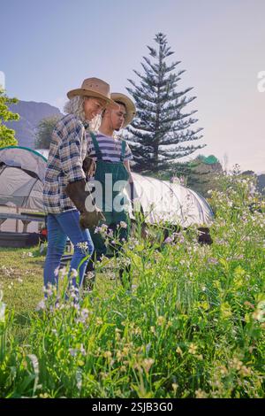 Man and woman looking at flowers in garden Stock Photo