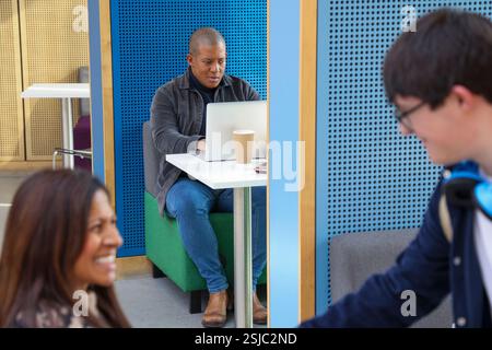 Disabled coworkers shaking hands in office Stock Photo