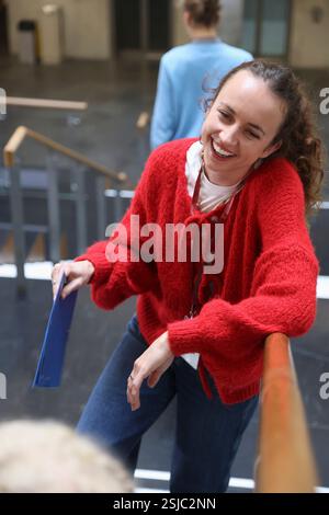 Smiling woman standing on stairs in community center Stock Photo