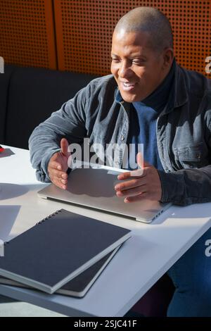 Disabled man sitting at desk Stock Photo