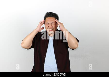 Man Suffering from very bad Headache, both hands on his head Stock Photo