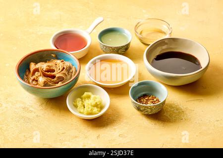 various salad dressing ingredients on yellow table background Stock Photo