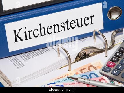 Church tax folder with money and calculator Stock Photo