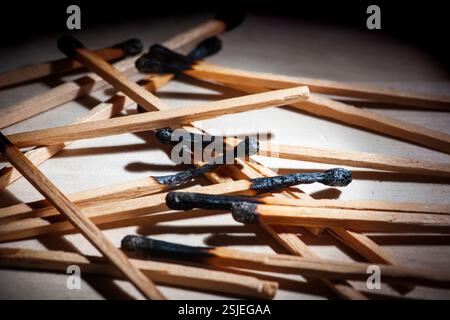 Low angle close-up view of burnt matches on a receding background. Stock Photo